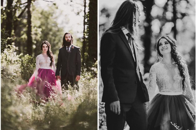 Elegant couple in wedding attire walking through a lush forest during daytime.