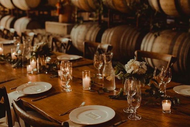 Elegant dining table setup with candles, glassware, and floral centerpieces at Maysara Events.