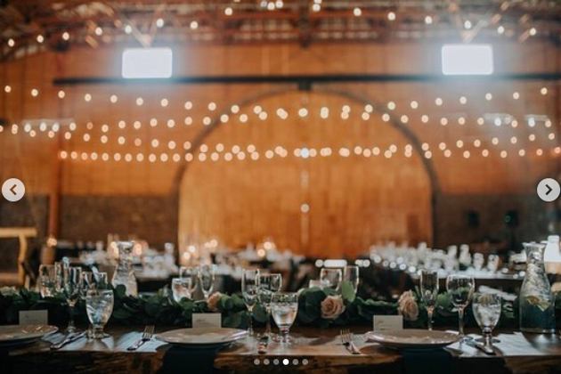 Elegant event hall with decorated tables and warm lighting for Maysara Events.